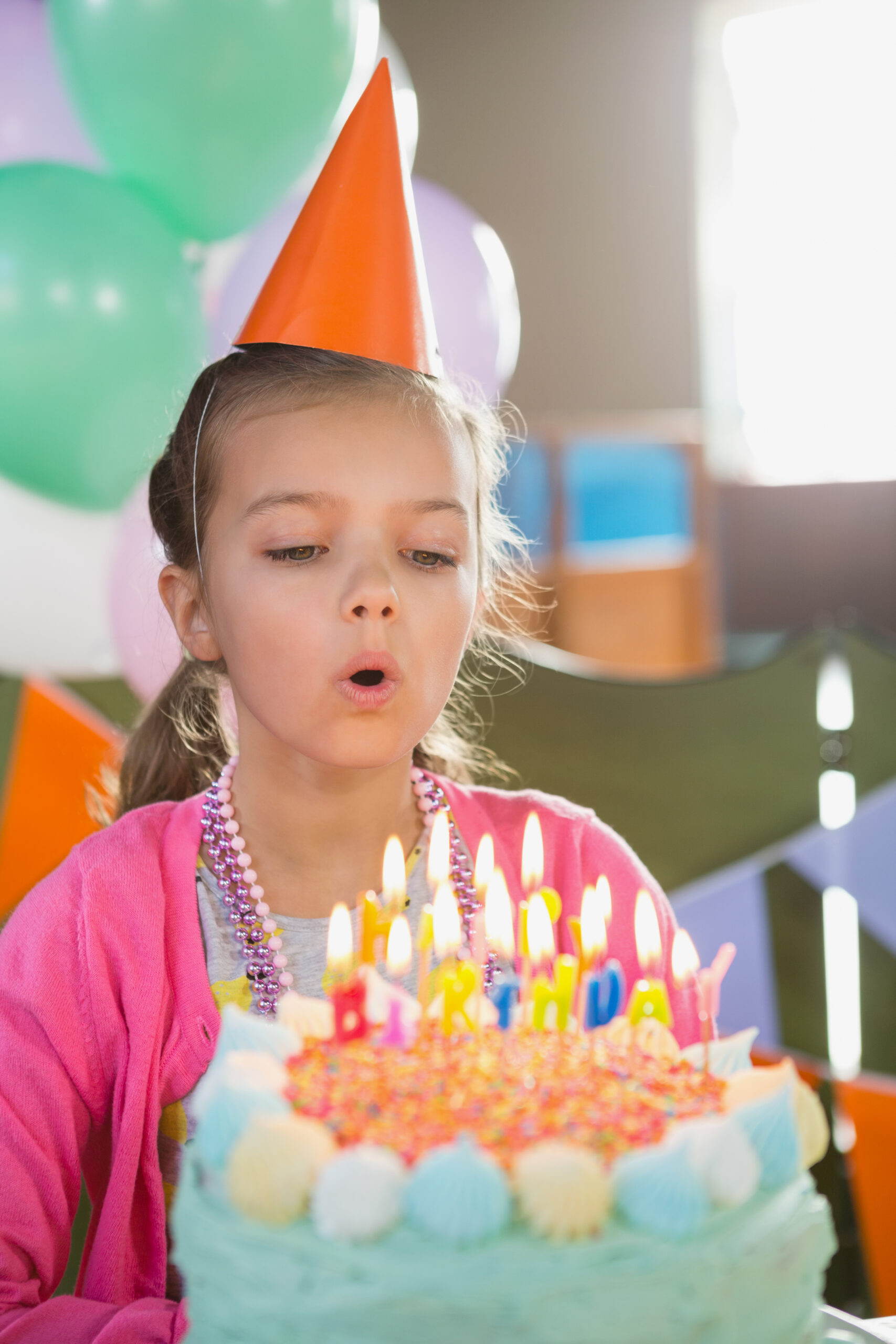 Birthday girl blowing birthday candles